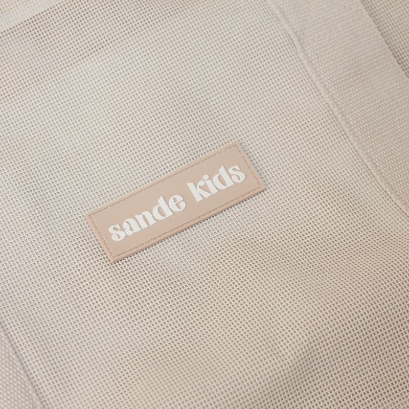 Mesh beach bag in a tones, thick cotton straps and silcone Sande Kids label.