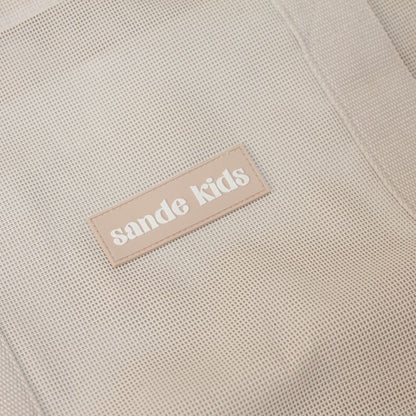 Mesh beach bag in a tones, thick cotton straps and silcone Sande Kids label.