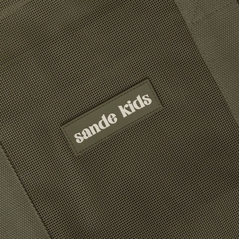 Sande Kids original mesh beach bag in Pandanus green, silicone label feature..